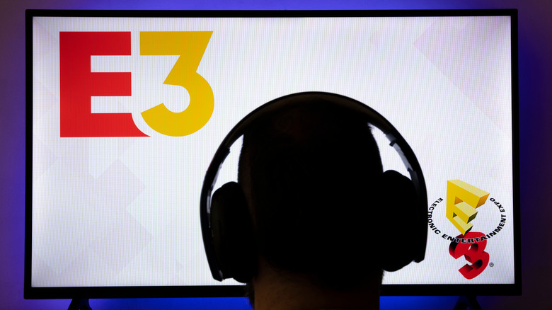 Person in front of a screen with the E3 logo