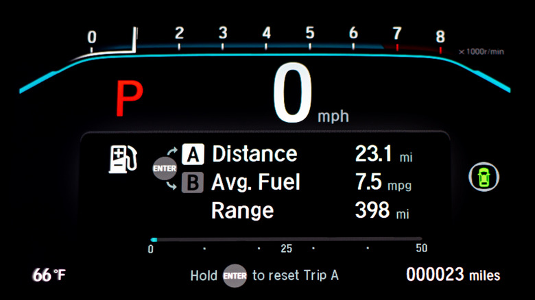 Car dashboard displaying fuel consumption and range