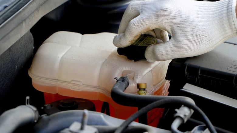 Orange coolant overflow bottle
