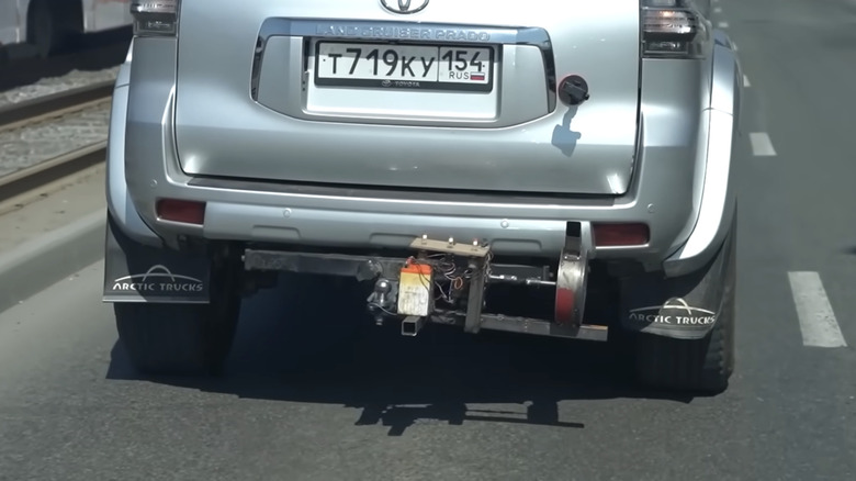 A Toyota SUV on the road with an exhaust-powered alternator installed on its rear