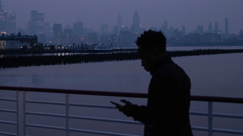 person in smoky air checking app