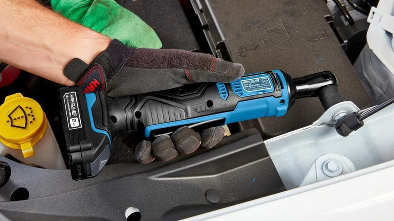 hand in black glove holding Hercules 12v ratchet