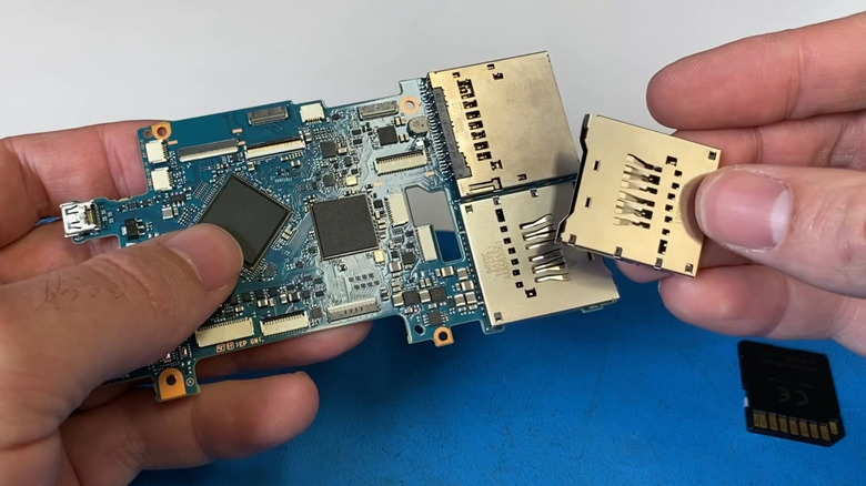 An SD card reader replacement module next to a faulty unit