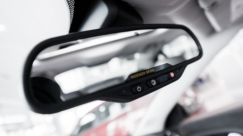 Car rear-view mirror with safety buttons