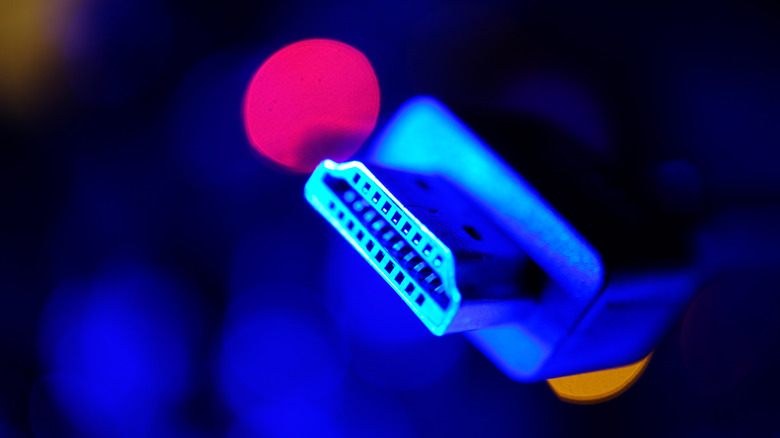 A close up of an HDMI chord against a psychedelic background.