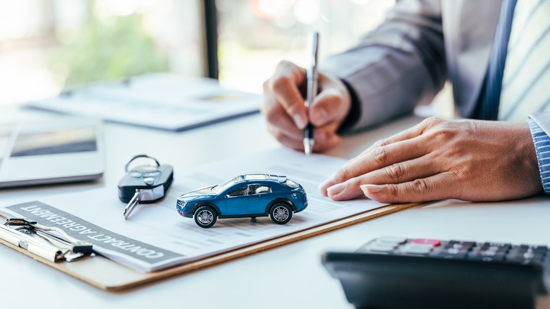signing paperwork to buy car