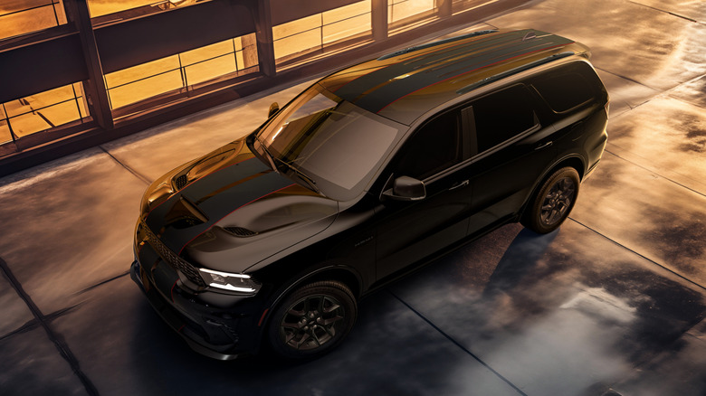 A picture of a black Dodge Durango R/T on a wet street.