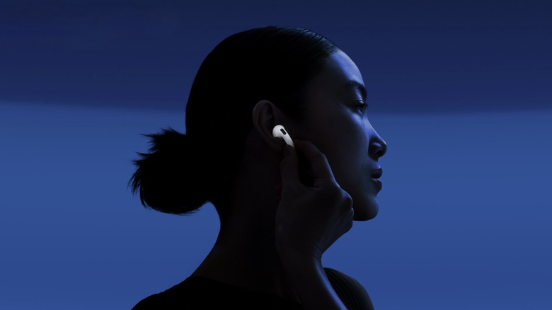 Person putting Airpod 4 in their ear