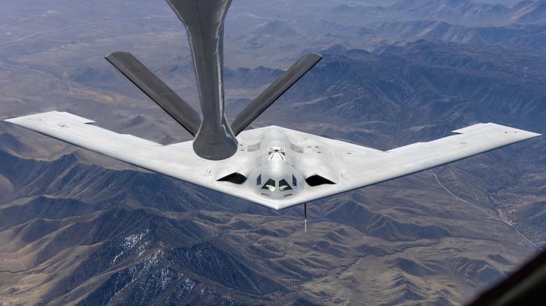 A B-21 Raider in flight during midair refueling