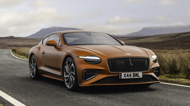 Orange Bentley Continental GT parked on a road
