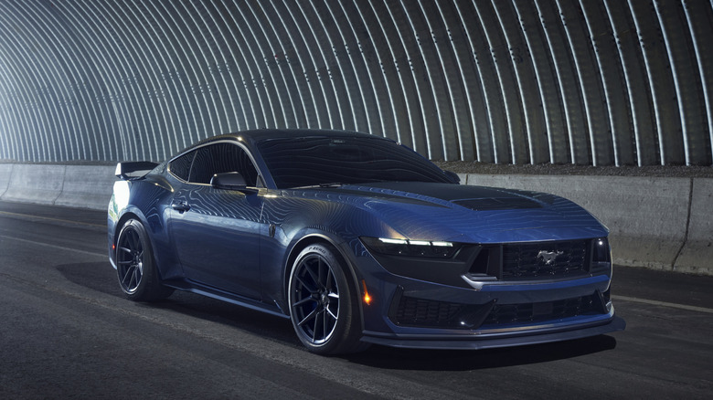 Blue Ford Mustang Dark Horse parked on a road