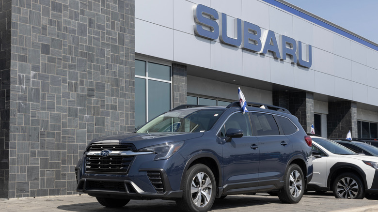 A Subaru outside a Subaru shop