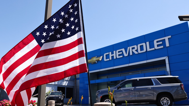 American flag in front of Chevrolet showroom