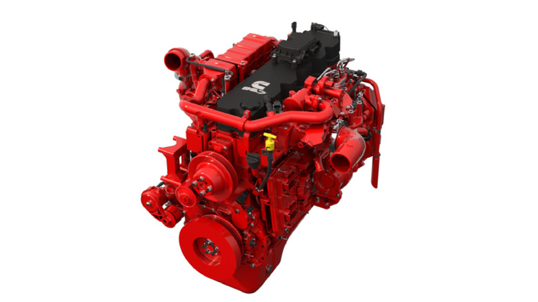Cummins B6.7 medium-duty engine in vivid red, shown on a white background with black valve cover