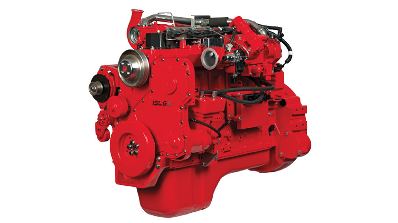Bright red Cummins ISL G engine on a clean white background, featuring a prominent turbocharger