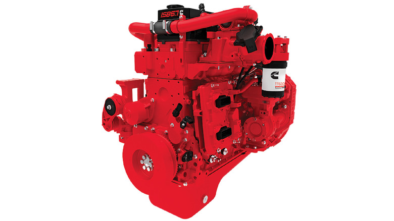 Red Cummins ISB 6.7 engine with visible turbo piping, accessory mounts, and branded oil filter