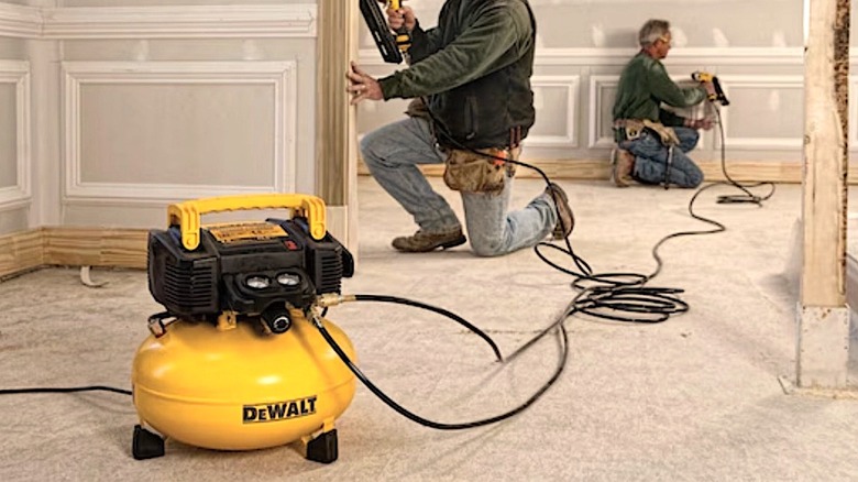 Workers using DeWalt compressor
