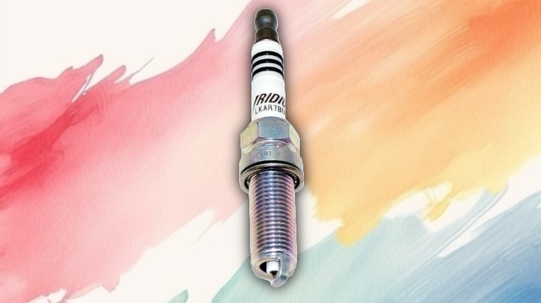 An iridium spark plug on a painted background.