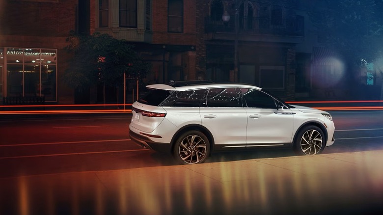 White 2025 Lincoln Corsair Reserve Edition SUV seen from right slightly rear parked on a city street at night
