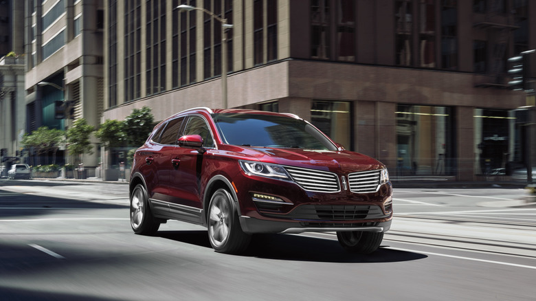 Dark red 2018 Lincoln MKC SUV seen from front right on city street