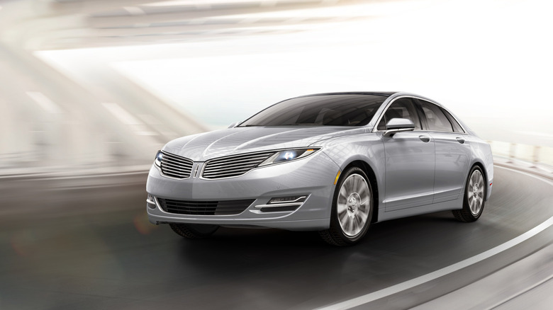 Silver 2012 Lincoln MKZ sedan seen driving under a bridge