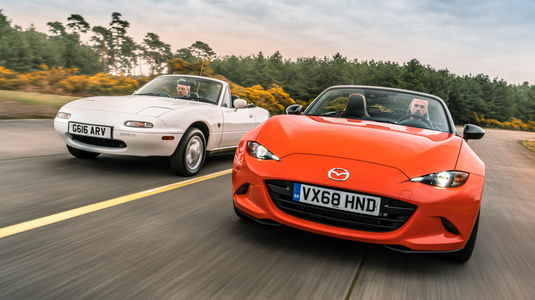 Front 3/4 views of Mazda Miata NA and Mazda Miata ND