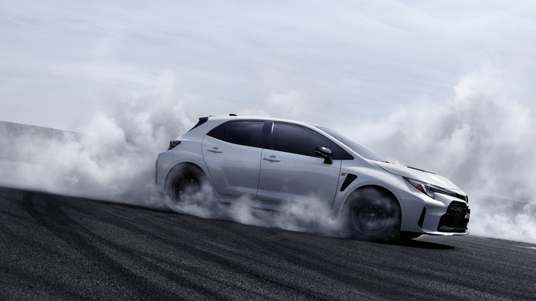 Toyota GR Corolla drifting on track side-to-front view