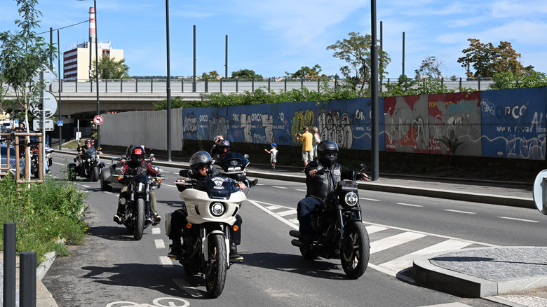 Harley-Davidson riders on custom touring motorcycles ride in formation during Prague Harley Days
