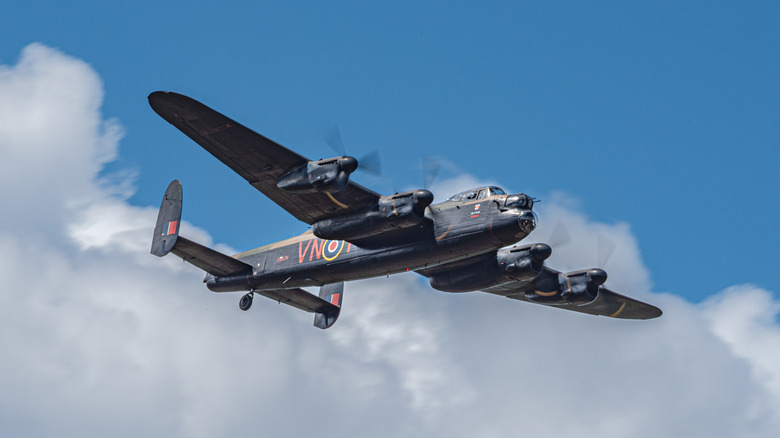 Heavy WWII bomber flying through blue sky