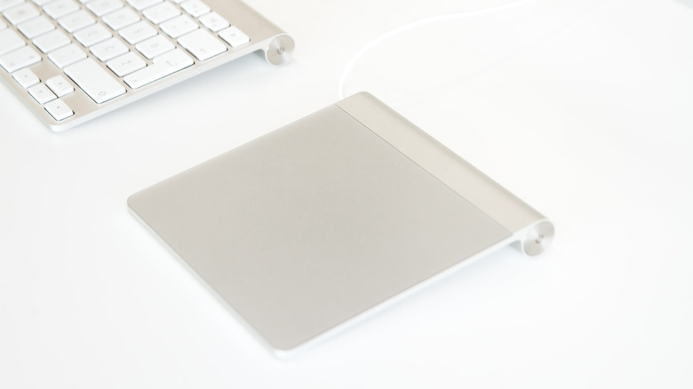 apple magic trackpad next to keyboard