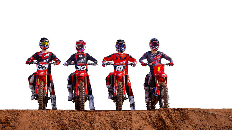 Four riders in sponsored jerseys and helmets lining up abreast on their Honda CFR150R bikes.