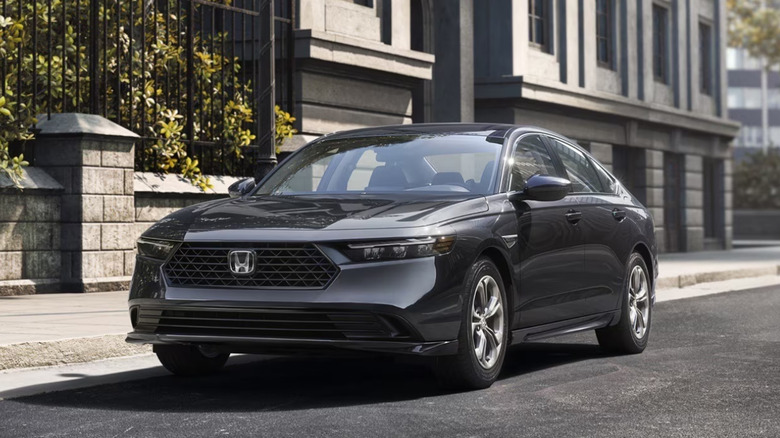 A black Honda Accord driving along a highway