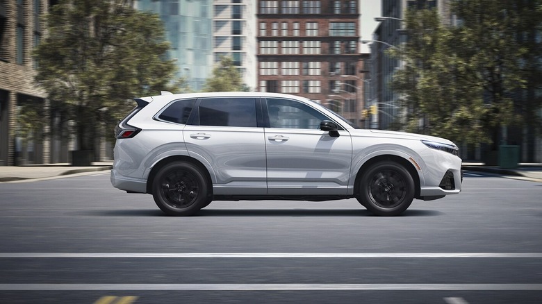 A white Honda CR-V e:FCEV driving in a city