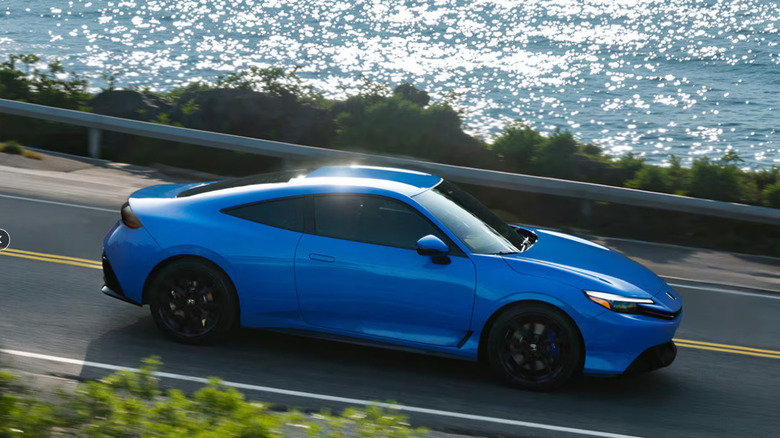A blue Honda Prelude driving
