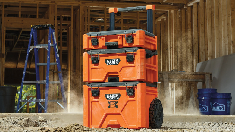 A bundle of three Klein Tools Modbox toolboxes one on top of the other. Lowe's branded buckets in the background.