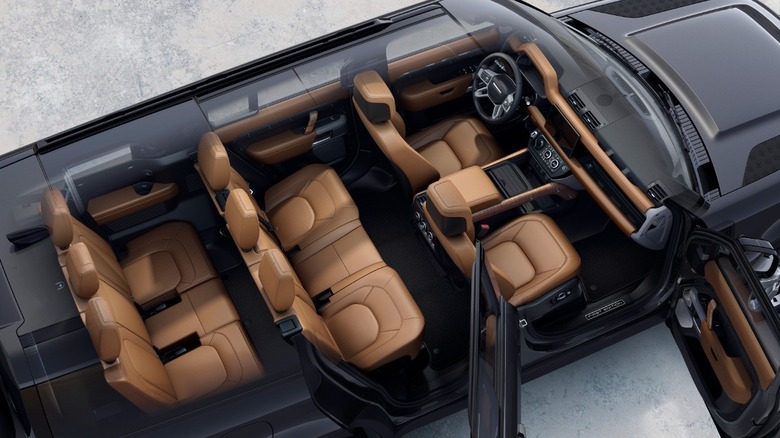 Interior cutaway view from above of the Defender 130, showing seven seat configuration in tan leather