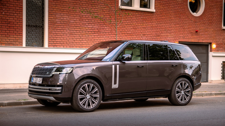 A brown Range Rover LWB Autobiography in front of a building in Bucharest, Romania