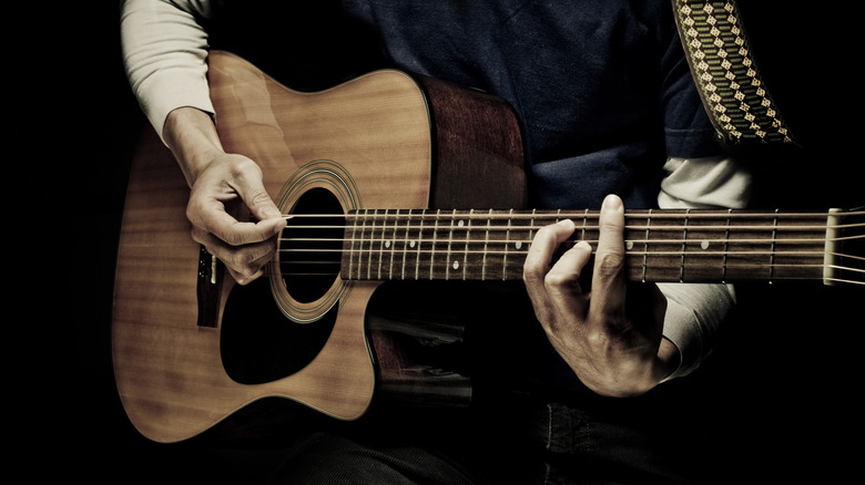 an acoustic guitar player