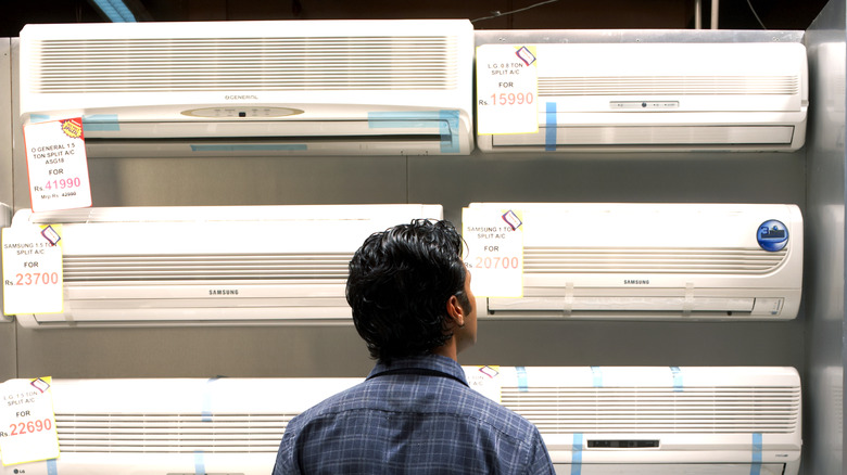 person looking at air conditioners in store