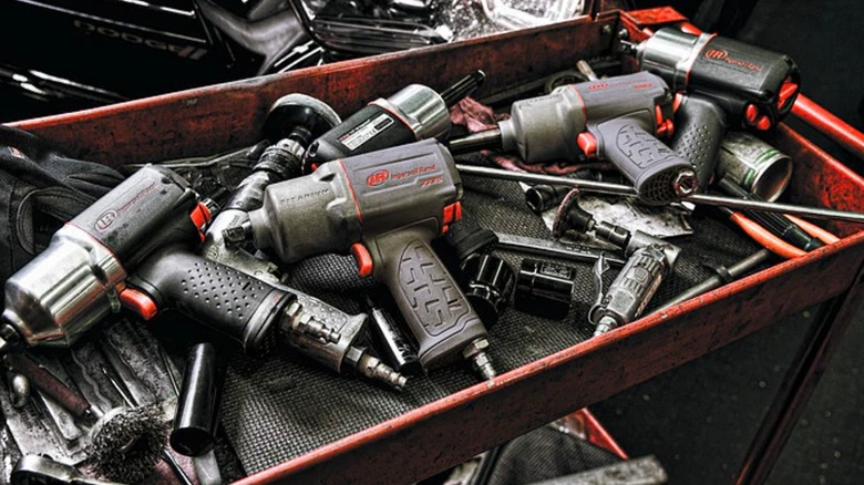 a bunch of Ingersoll Rand air tools on shop cart