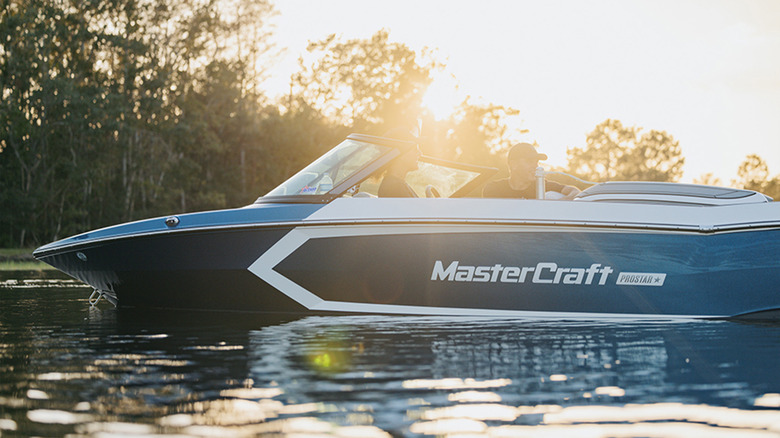 A Mastercraft Prostar boat at sunrise on the water
