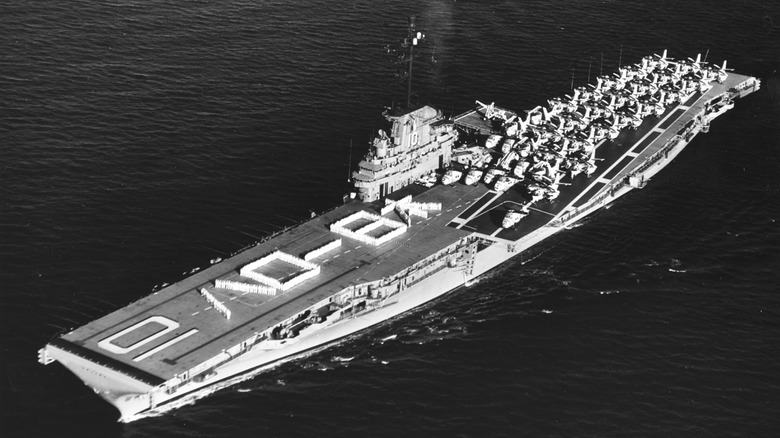 The USS Yorktown underway in 1960 with "Hello Japan" in Japanese characters spelled out on the deck