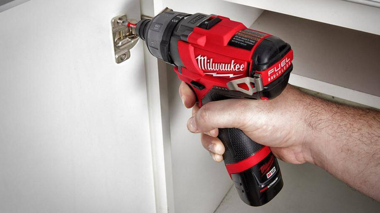 The Milwaukee Fuel power screwdriver used on a cabinet door.