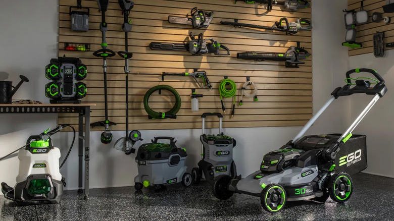 Several Ego Power brand tools in the corner of a garage