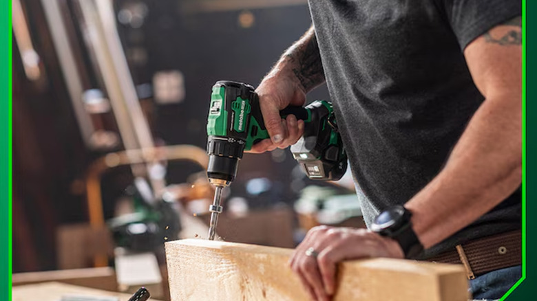 A man drilling into a piece of wood with a Metabo drill