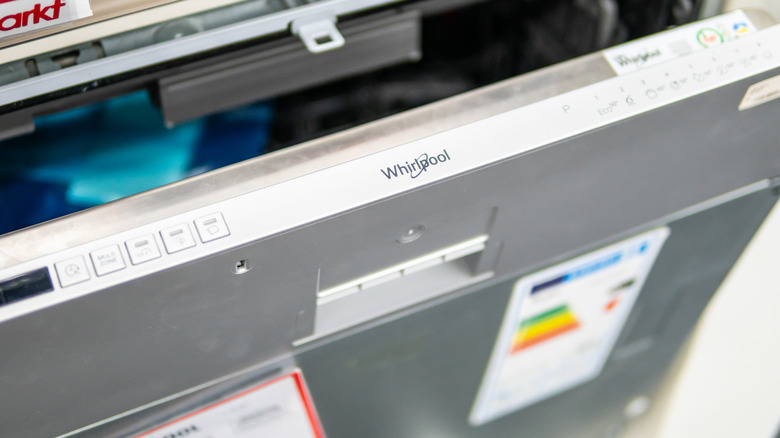 An open Whirlpool dishwasher door