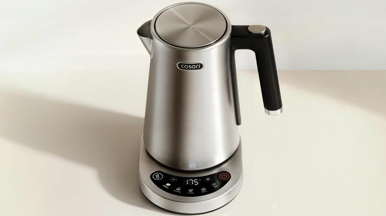 Cosori stainless steel electric kettle sitting on its base