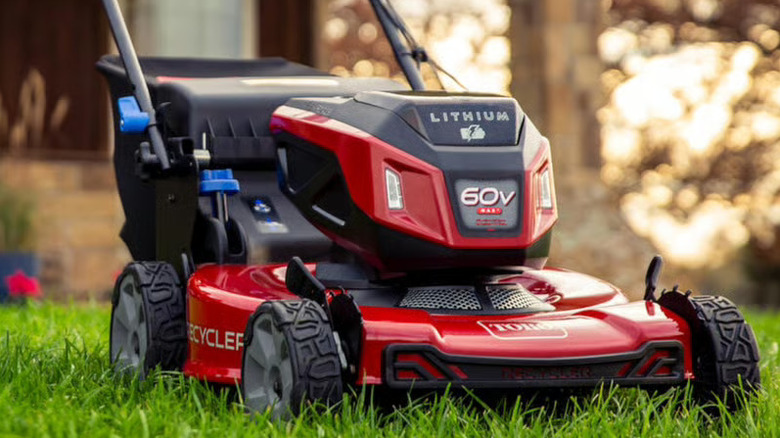 Focus on the Toro Recycler lawn mower sitting on a front lawn