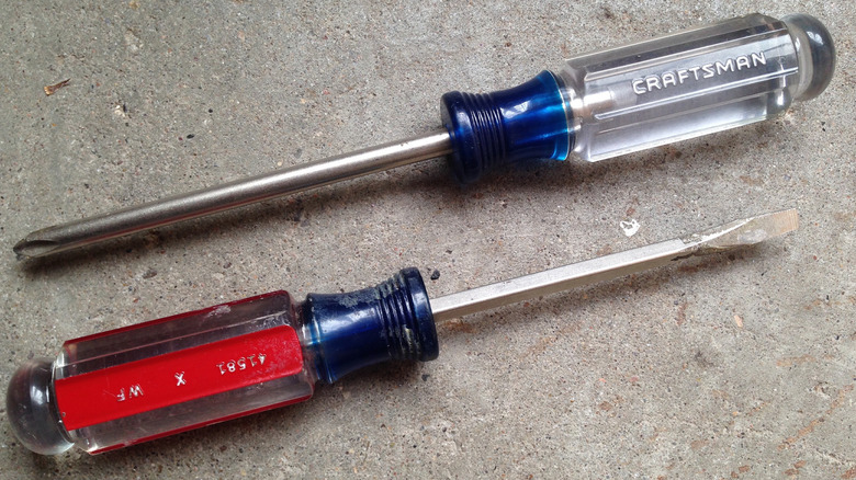 Two Craftsman screwdrivers on a concrete floor