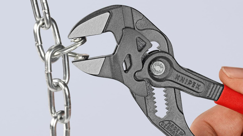 A Knipex Pliers Wrench benching a piece of chain link